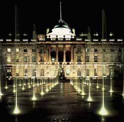 Somerset House at night with floodlit fountains