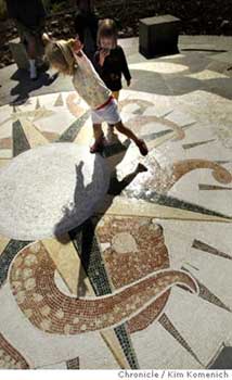 Children skip atop Pippa Murray's The Gathering Place mosaic outside the Bay Area Discovery Museum in Sausalito. Chronicle photo by Kim Komenich